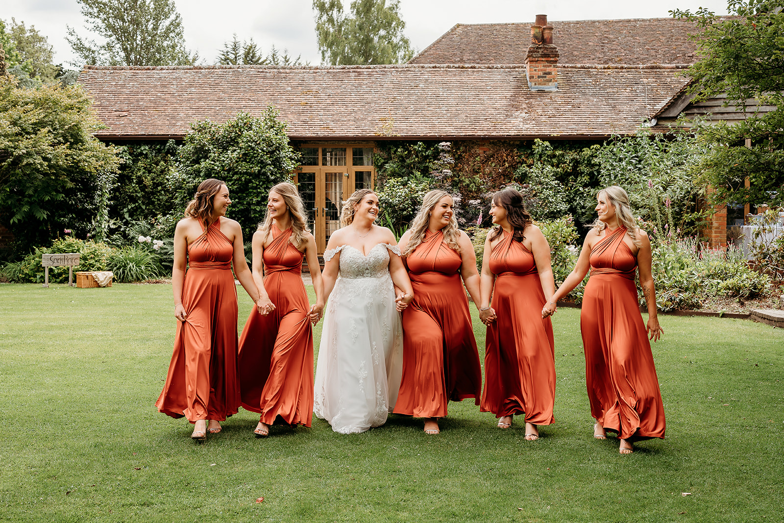 bride and her bridesmaids at Rivervale Barn captured by a hampshire wedding photographer